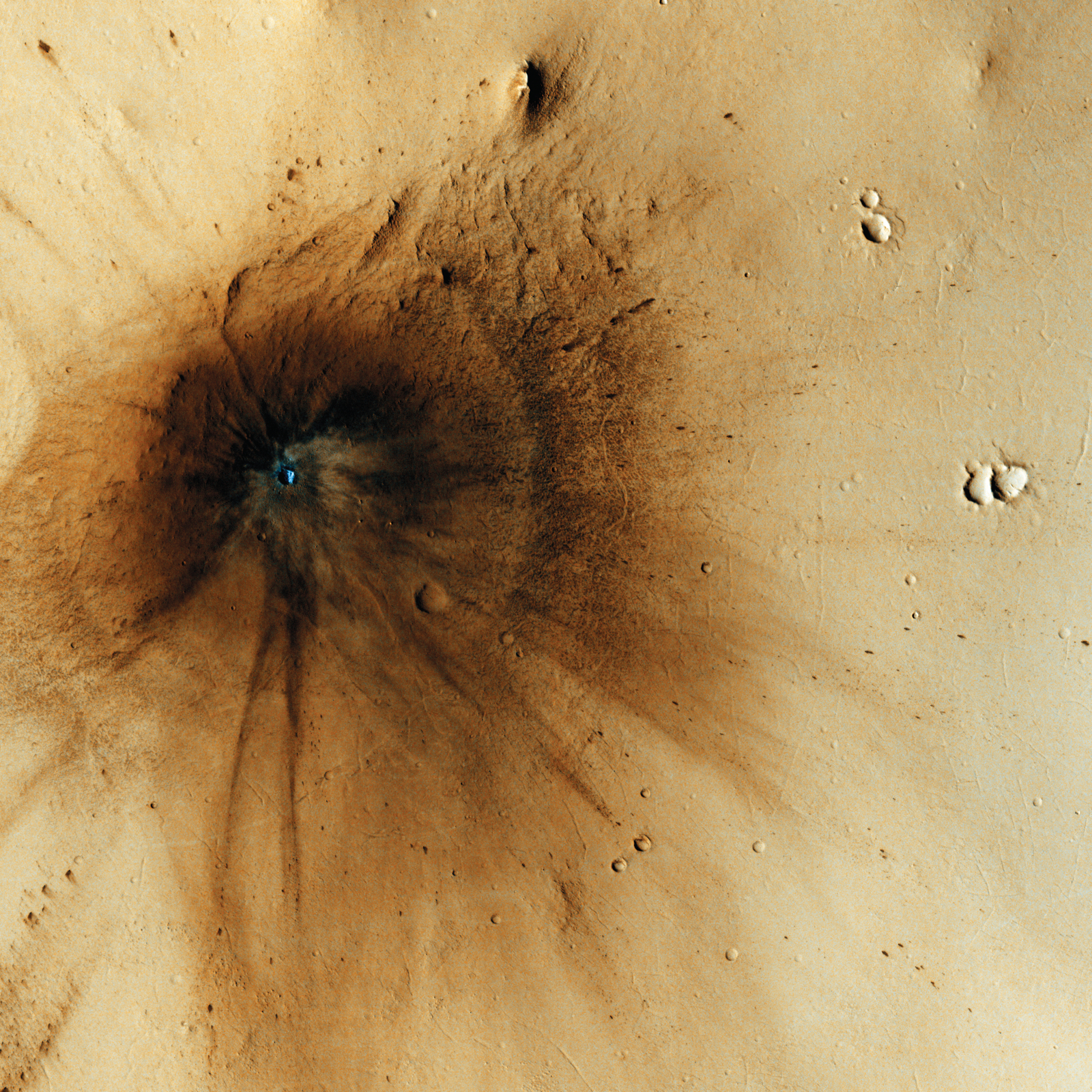 This impact occurred between December 2003 and November 2005. The main crater itself is only 23 meters across, but the impact event created markings spreading more than a kilometer outward. The interior stands out as blue because the impact excavated a ca